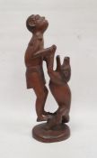 Tribal hardwood carving, group of man and animal, signed to base K Ukando, 41cm high