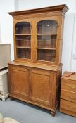 19th/early 20th century oak library bookcase with ogee cornice over round arch glazed doors, on
