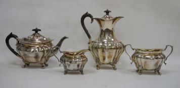 Edwardian silver tea and coffee service, comprising: a fluted baluster coffee-pot and cover, 24 cm
