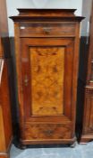 Continental walnut cupboard with single drawer above cupboard door, canted corners, on bun feet,