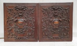 Pair of mahogany, heavily carved, wall hangings, each 52cm x 59cm (2)