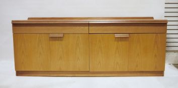 Mid century modern teak sideboard with two drawers above two bi-fold cupboard doors, on plinth base,