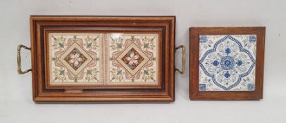 Wooden two-handled tray inset two old printed ceramic tiles and with embossed brass handles, 43cm