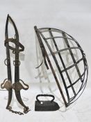 Hay feeder, a flat iron and horse yoke.