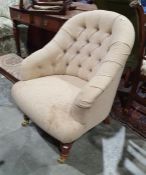 Modern oatmeal upholstered chair on turned supports to brass caps and castors