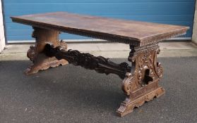 17th/18th century Italian walnut trestle table, the rectangular top on carved and shaped end