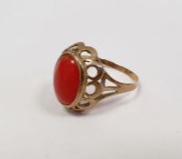 Gold-coloured metal and coral ring set oval cabochon stone, the ring marked '333'