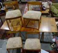 McIntosh mid-century modern teak dining table and four chairs with upholstered seats, on cylindrical