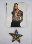 Yves Saint Laurent  paste star brooch with necklace loop, with a fashion page photo of the brooch
