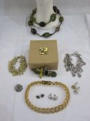 Alexandra Abraham brooch with gold detailing and coloured stones in its original box, a vintage