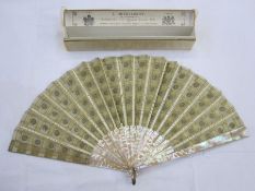 A late 19th Century fan embroidered with silver and gold sequins, mounted on cream mother-of-pearl