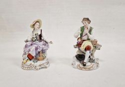 Pair continental porcelain figures of lady seated with flowers and basket of flowers at her feet,
