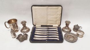 Silver and white metal items to include, mug, lidded salt and pepper, weighted silver