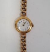 Lady's 18ct gold wristwatch with blue enamel Arabic numerals to the circular white dial, side button