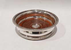 George III silver and turned mahogany wine bottle coaster with green felt base, London 1807 by TR