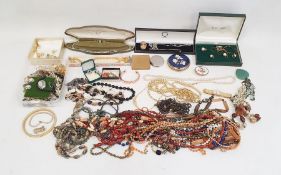 Large quantity of beaded necklaces, powder press boxes, assorted brooches, some gold-coloured ladies