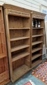 Pair of 20th century pine open bookcases with applied moulded cornices, on plinth bases (2)