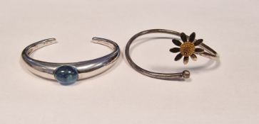 Baccarat silver and blue stone set cuff bangle and an Andrew Scott silver 'Lazy Daisy' bangle with