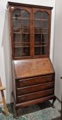 20th century walnut bureau/bookcase, the moulded cornice above two astragal-glazed doors enclosing
