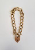 9ct gold chain link bracelet, flattened and engraved curb pattern with heart shaped padlock clasp,
