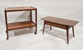 Mid century modern teak coffee table with slide out top opening to reveal storage compartment, on