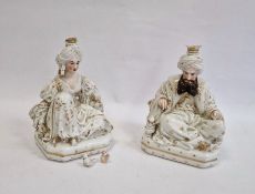 Pair Continental porcelain scent bottle candle holders each of seated figure of an Eastern couple,