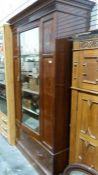 Late 19th/early 20th century single-door wardrobe by Maple and Co, in mahogany, the moulded