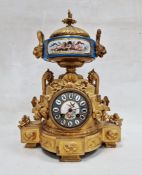 19th century French ormolu and porcelain mantel clock with striking movement ,with foliate finial