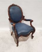 Victorian armchair in blue upholstered seat, back and armrests, heavily carved frame, serpentine-