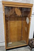 Oak and glazed shop display cabinet on plinth base, 112cm x 193cm