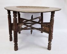 Large Eastern-style brass and engraved tray on folding hardwood base (76 cm diameter)