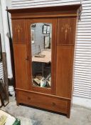 Edwardian mahogany and inlaid wardrobe with moulded cornice above single mirrored door, above single