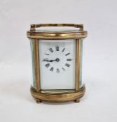 20th century brass and glass carriage clock with oval body, Roman numerals to the dial, 11cm high