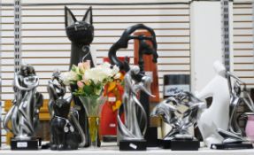 Collection of De Caprio figures and various wooden sculptures of cats