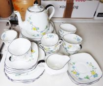 Heathcote china part tea service in white with blue and yellow floral spray decoration, black