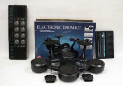 Boss BE5 multiple-effects guitar pedal, a Yamaha drum machine, an electric drum kit and various