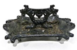 Cast iron black painted boot scraper and a small quantity of textiles, 40cm wide