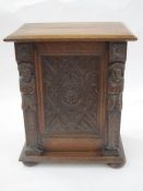 Early 20th century oak smoker's cabinet, the framed panel door carved with foliate and lozenge,