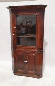 Antique oak floor standing corner cupboard with cavetto cornice, glazed upper section having two