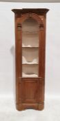 Modern pine corner unit with assorted shelves above cupboard door, on bracket feet, 200cm high
