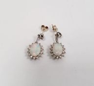 Pair of 18k white gold, diamond and opal drop stud earrings  Condition Report1 opal with cracks.  We