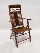 Vintage folding chair with green upholstered headrest, backrest and seat