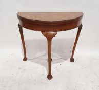 20th century walnut D-shaped foldout card table raised on claw and ball feet, 72cm x 82cm x 41cm (