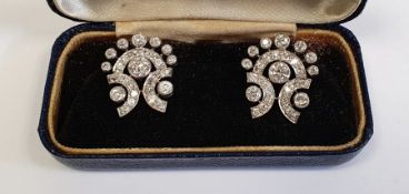 Pair diamond and white metal earrings, each lyre-shaped and set with multiple stones, each having