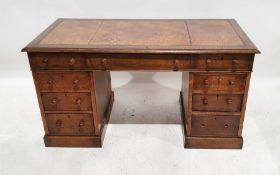 Early 20th century oak pedestal desk with brown leather inset top, nine assorted drawers, on