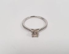 Platinum solitaire diamond brilliant-cut ring, claw-set with multiple diamonds to the shoulders, the