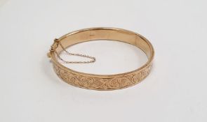 9ct gold bangle, engine-turned and foliate scroll engraved, 12g approx.