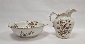 Staffordshire pottery ewer and basin decorated with exotic bird and rose branches