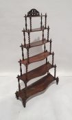 Victorian rosewood six-tier waterfall whatnot, each serpentine fronted tier supported by