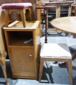 20th century oak single-door cupboard with rounded front corners above open recess cupboard door, on